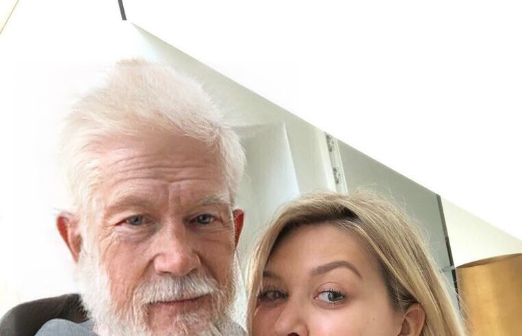 An older man and woman posing for a selfie.