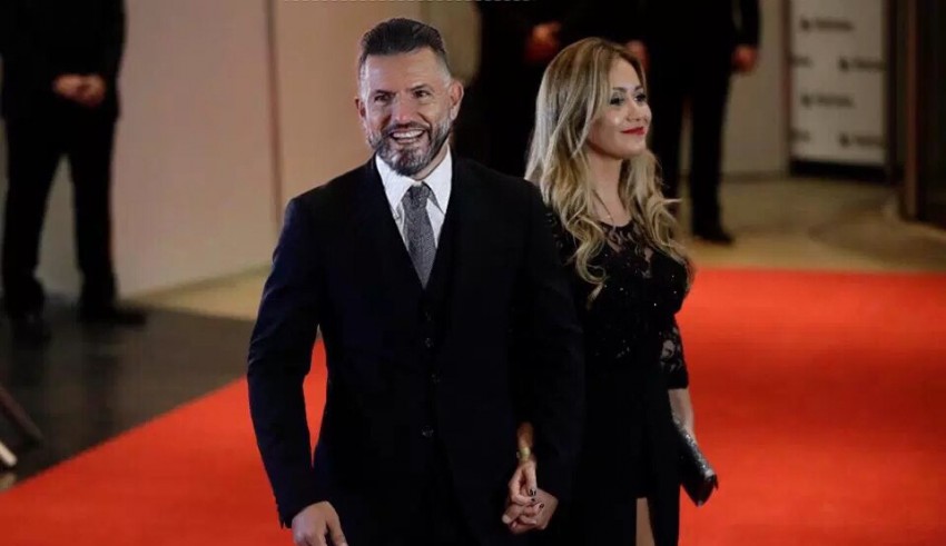 A man and woman walking down a red carpet.