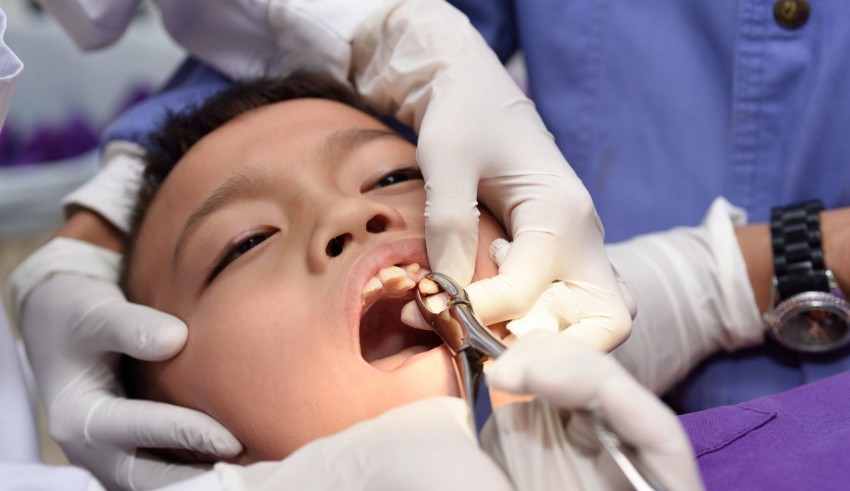 A child is being examined by a dentist.