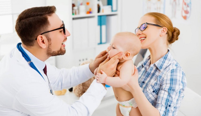 A baby is being examined by a doctor in a doctor's office.