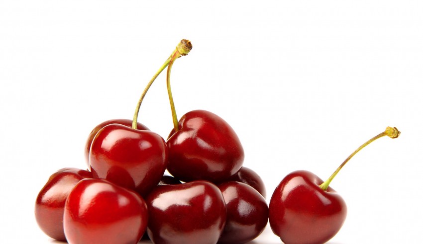 A pile of cherries on a white background.