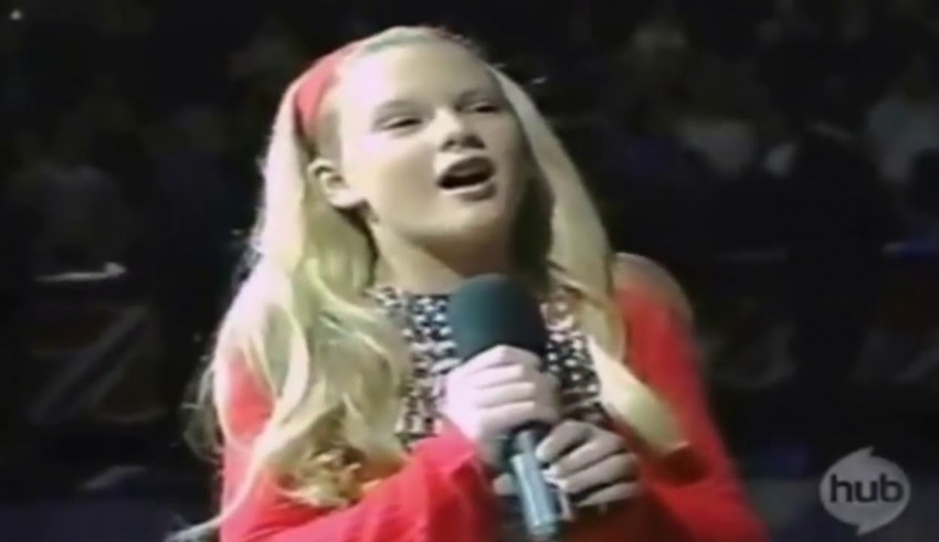 A young girl singing into a microphone.