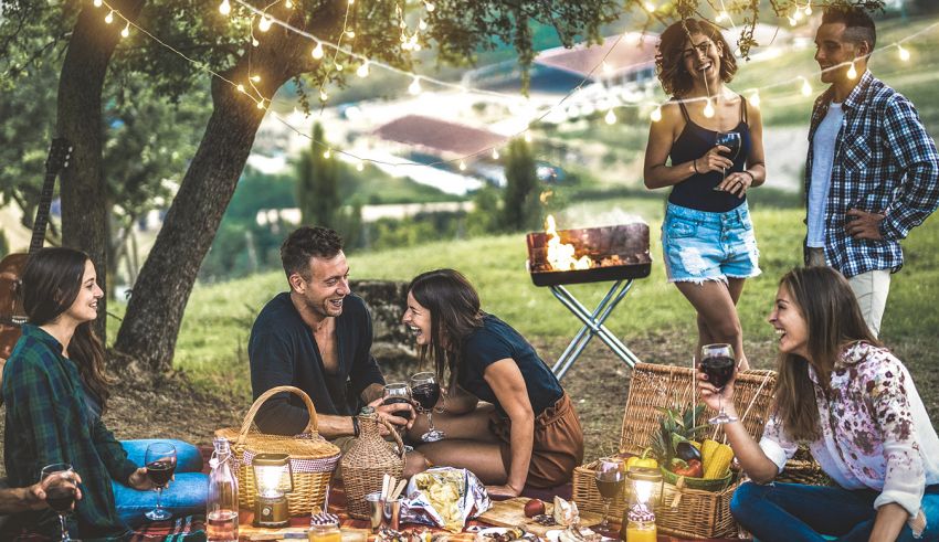 A group of friends having a picnic in the woods.