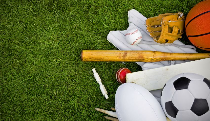 A group of sports equipment laying on the grass.