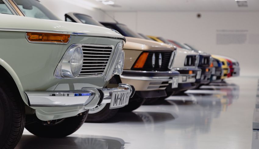 A row of cars parked in a museum.