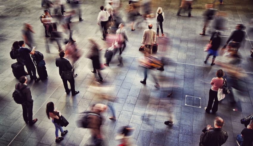 A group of people walking in a busy area.