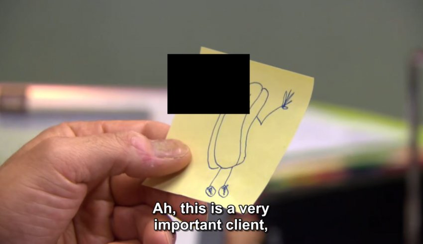 A person holding up a sticky note that says ah this is a very important client.