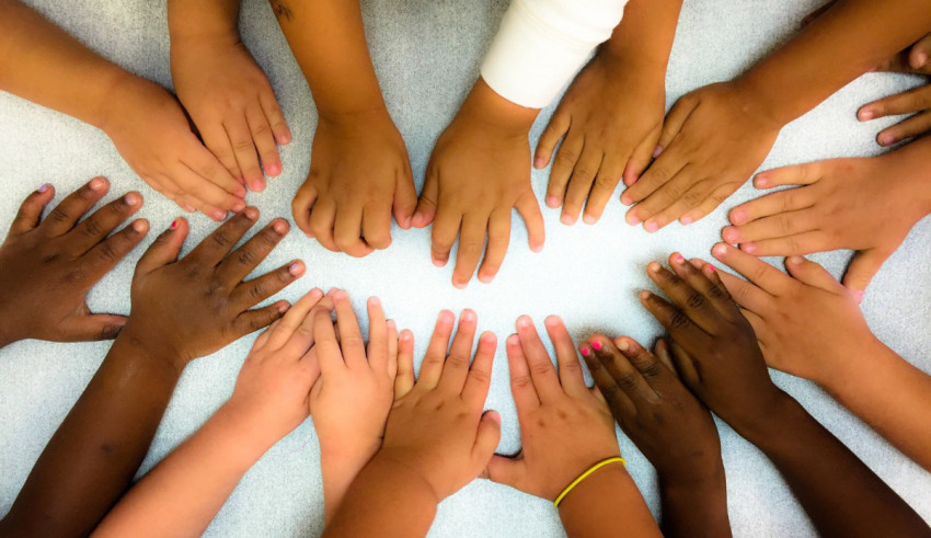 A group of children's hands in a circle.