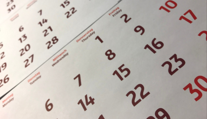 A calendar with red numbers on it.