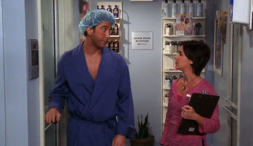 A man and woman in scrubs standing in a hallway.