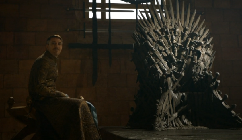A man sits on the iron throne in game of thrones.