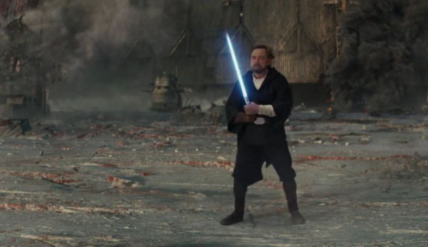 A man holding a star wars light saber.