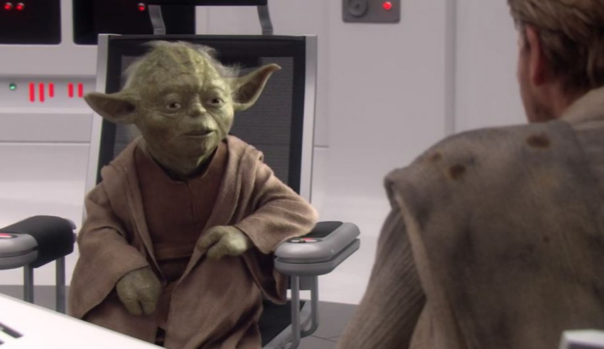 Star wars yoda sitting in a chair.