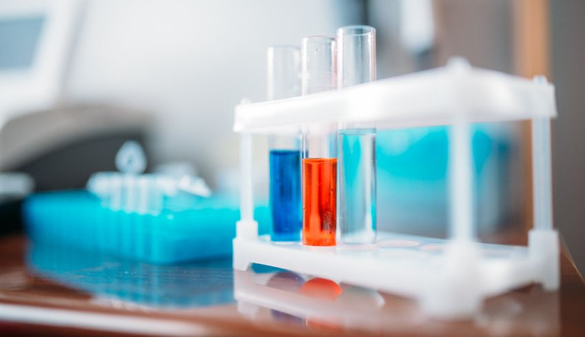 A test tube with blue and red liquids on a table.
