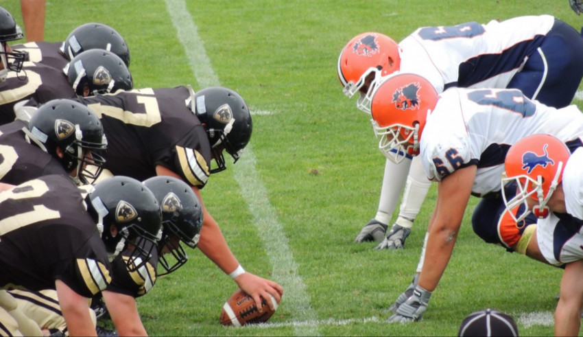 A group of football players are lined up for a game.