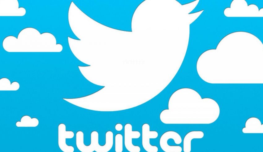 A white twitter logo with clouds in the background.