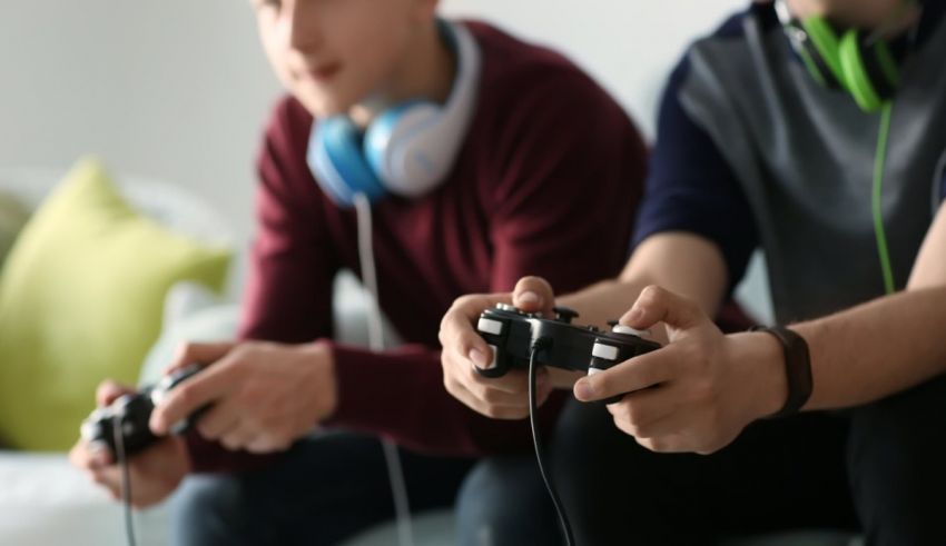 Two young men playing video games on a couch.