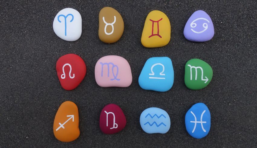 A group of stones with different zodiac signs on them.