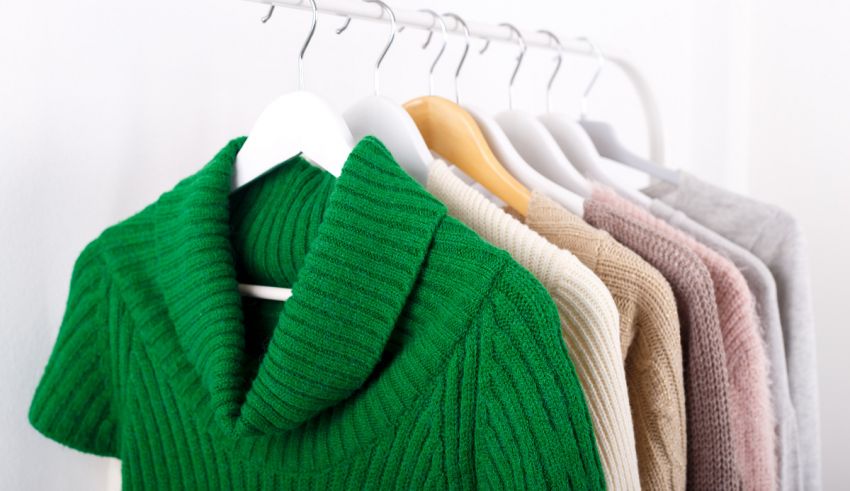 Green sweaters hanging on a hanger.