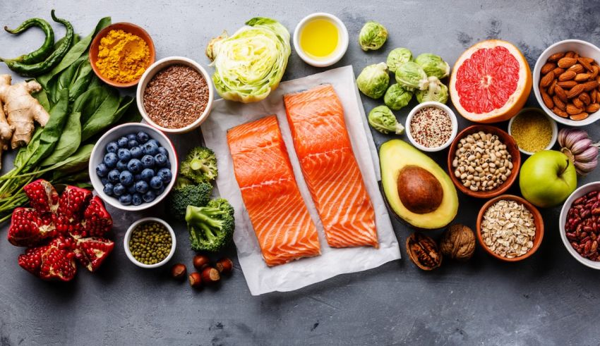 A variety of foods including salmon, vegetables and fruits.