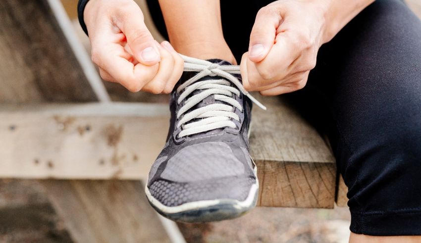 A person tying up a pair of running shoes.