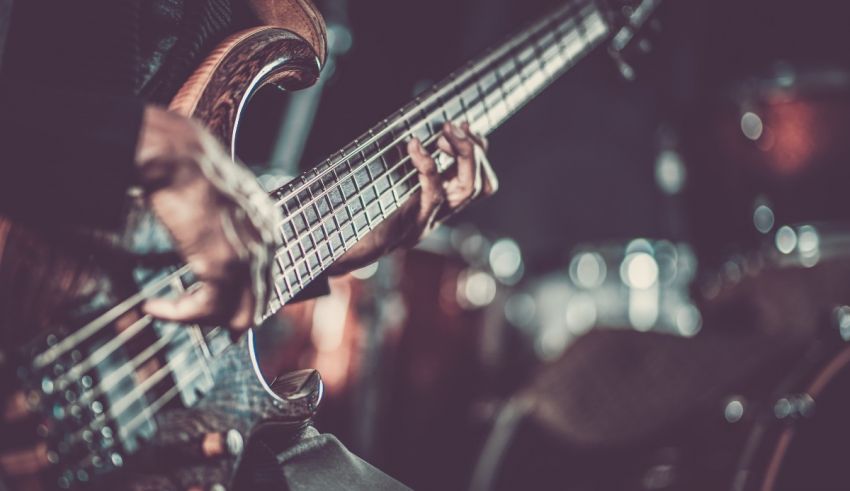 An image of a person playing a bass guitar.