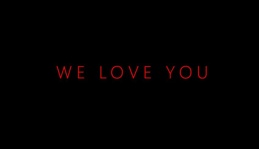 A black background with the words we love you on it.