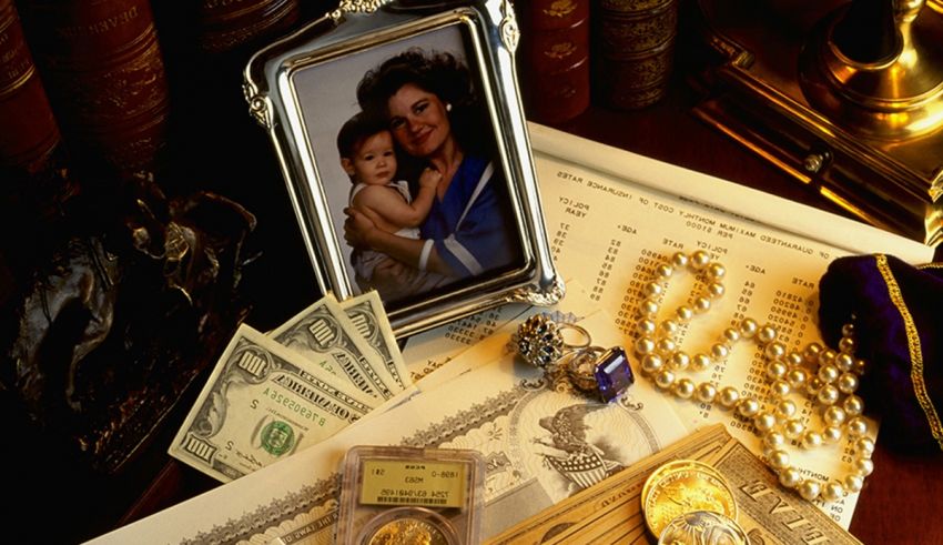 A picture of a child with a gold frame and money on a desk.