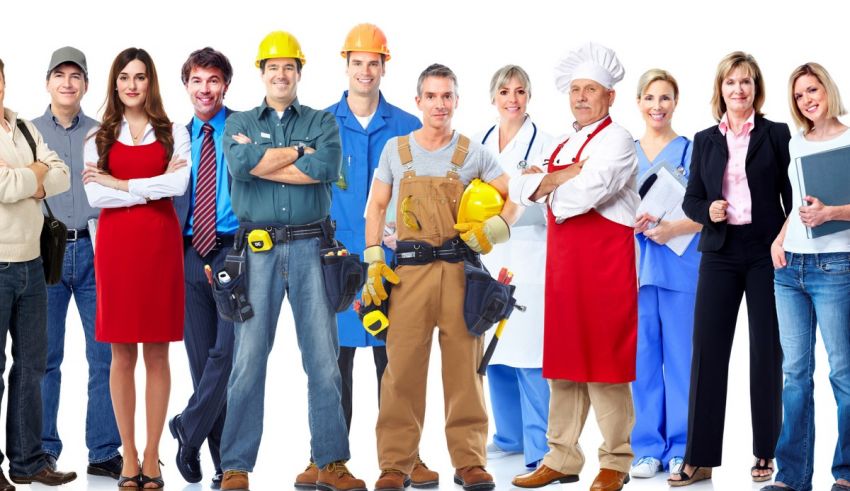 A group of construction workers posing in front of a white background.