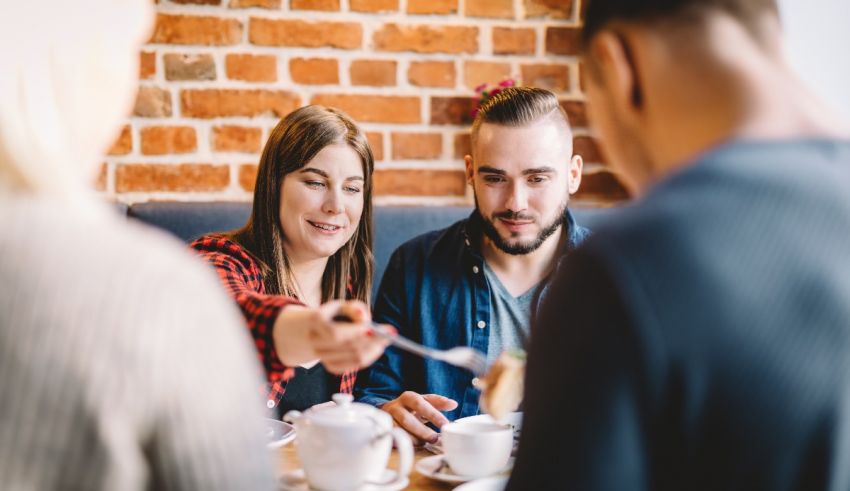 A group of people sitting at a table and having a meal.