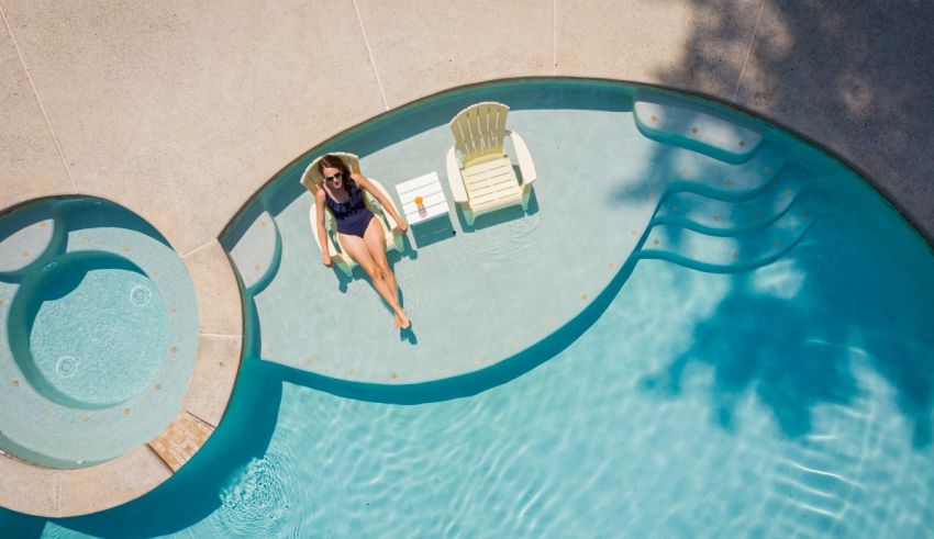 A woman relaxes in a chair in a swimming pool.