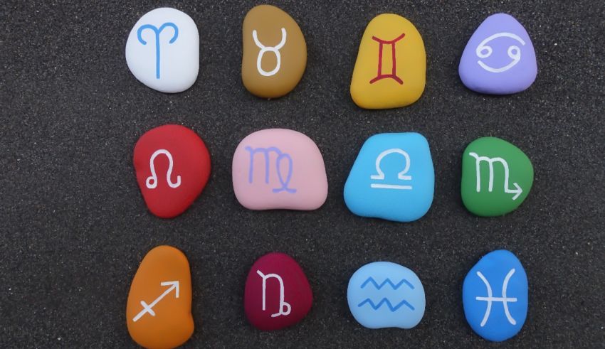 A group of stones with different zodiac signs on them.