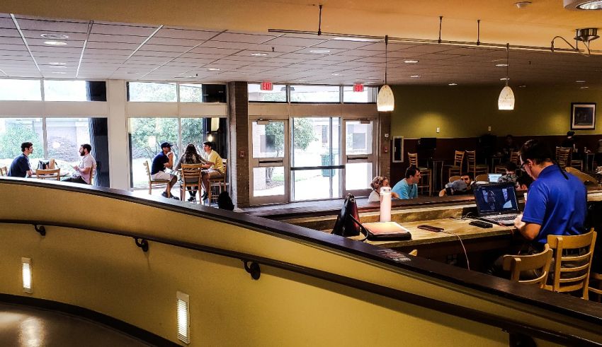 A group of people sitting at a table in a cafe.