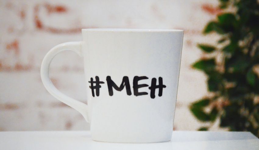 A coffee mug with the word meh on it.