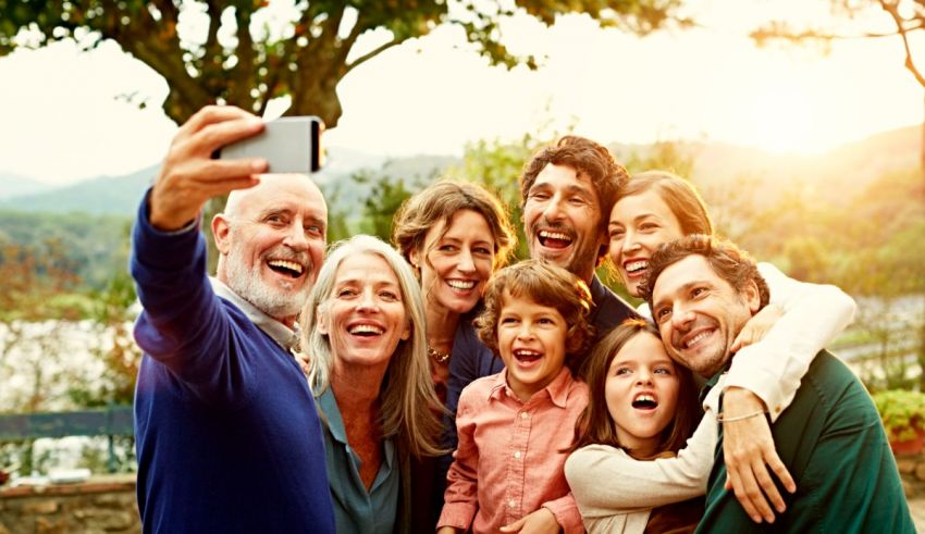 A group of people taking a selfie with a cell phone.
