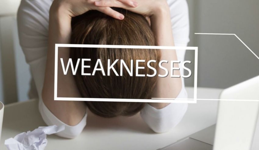 A woman is sitting at a desk with the word weaknesses written on it.