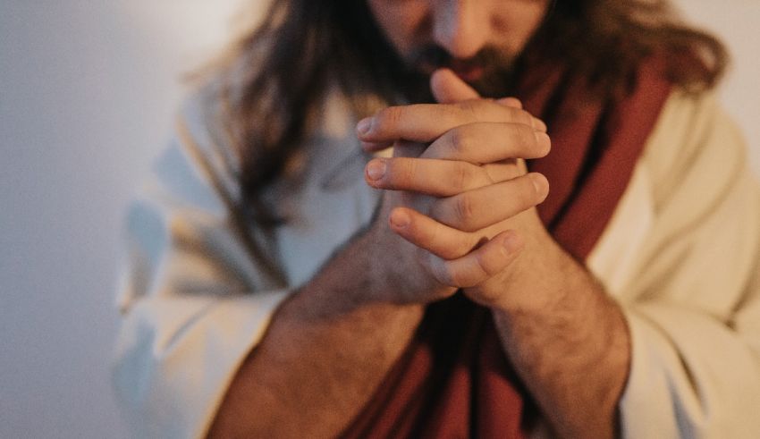 Jesus praying with his hands in his lap.