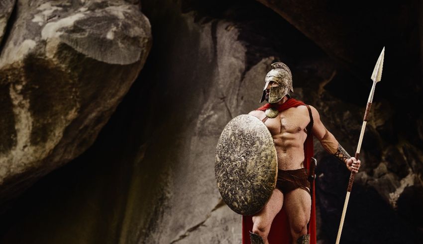 A spartan man holding a spear and shield.