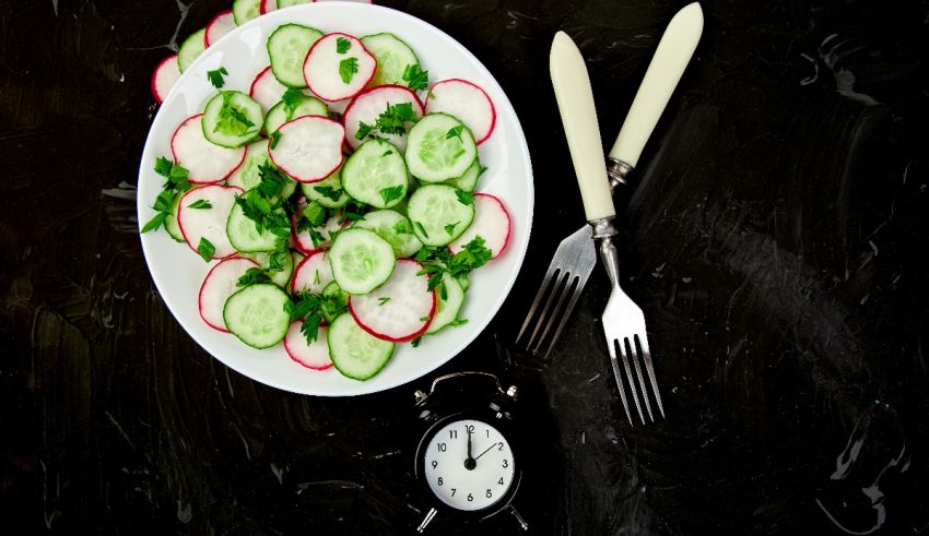 A plate with radishes and a fork.