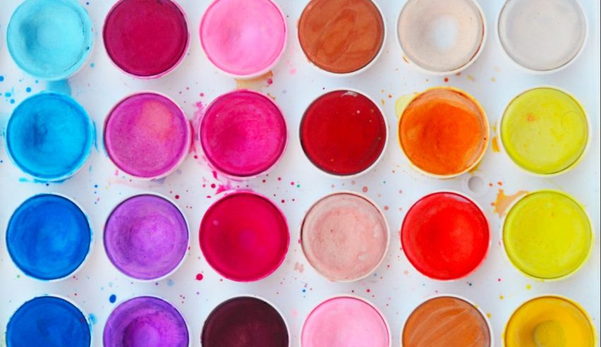 A set of colorful paint bowls on a white background.