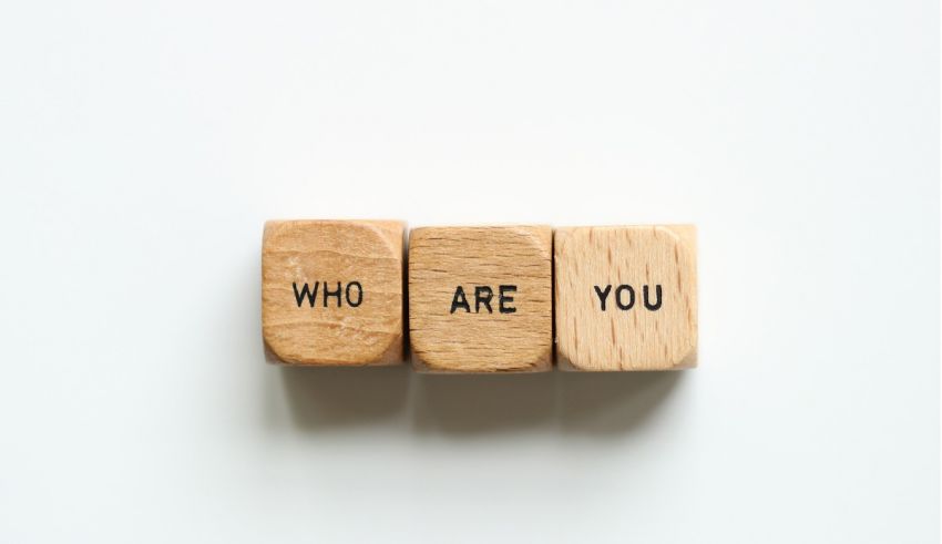 Three wooden blocks with the word who are you on them.