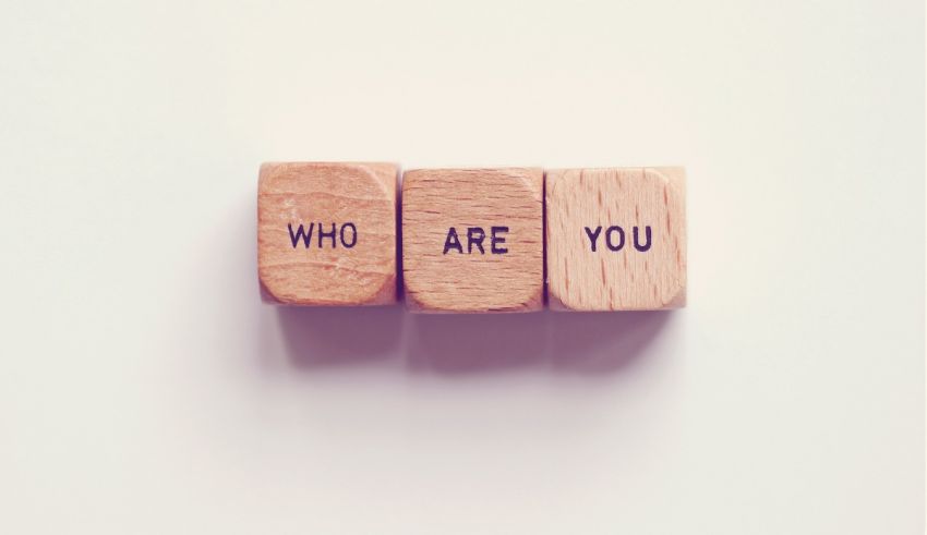 Three wooden blocks with the word who are you on them.