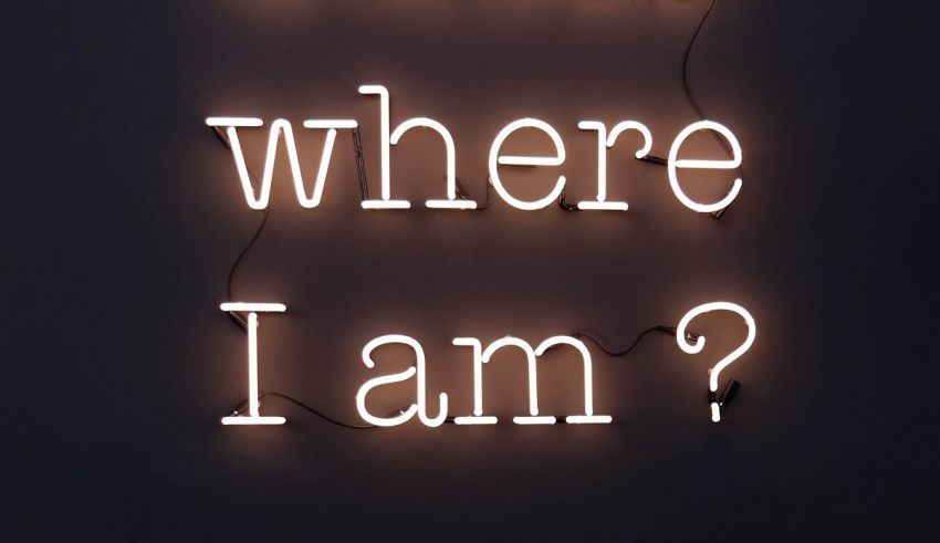 A neon sign that says where am i?.