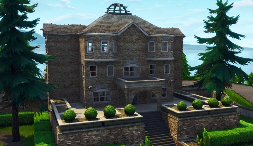 A fortnite house with trees and bushes.