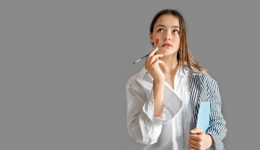 A woman is holding a pen and looking at something.