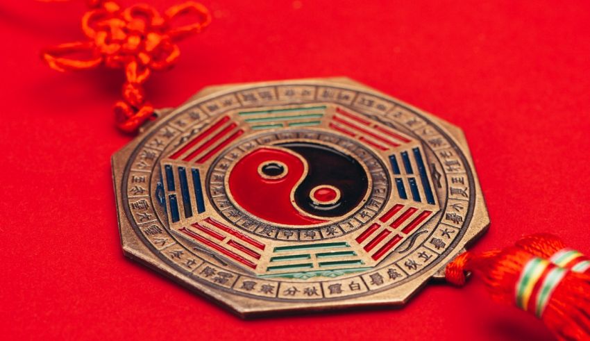 A chinese yin yang symbol on a red background.