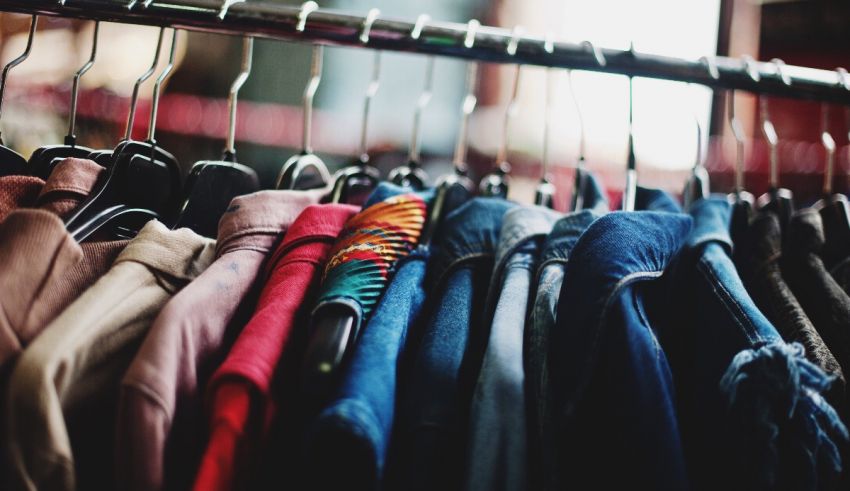 Clothes hanging on a rack in a store.