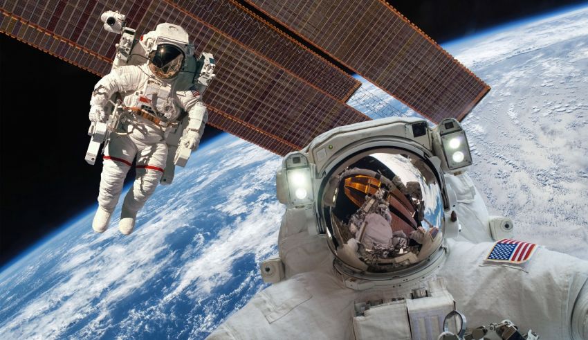 An astronaut in space with a camera in front of him.