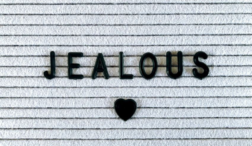 A black heart with the word jealous on it.