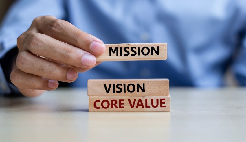 A man holding wooden blocks with the words mission and core value.